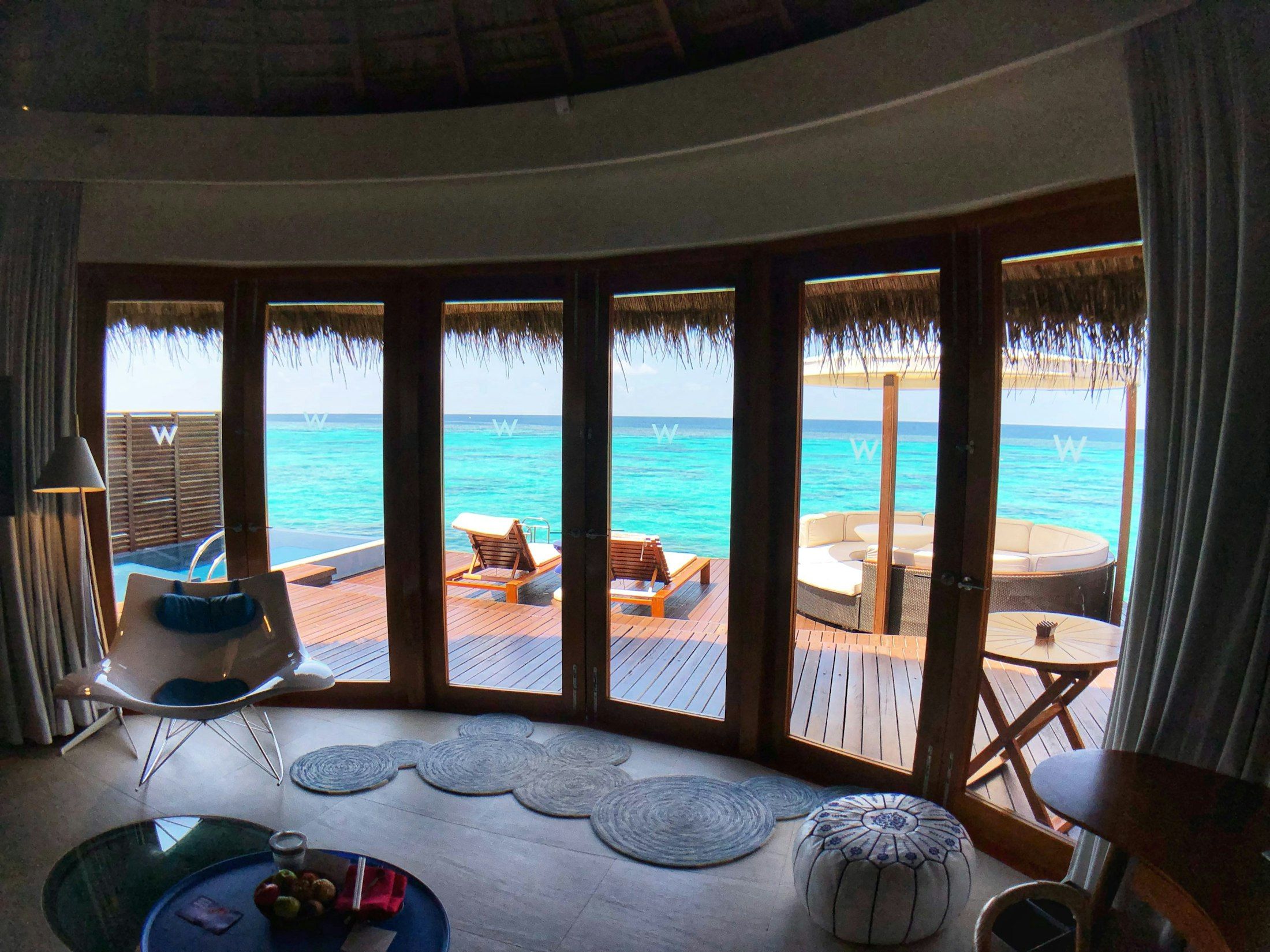 Overwater villa deck above a turquoise lagoon